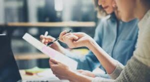 Two professionals collaborating on document review for accurate translation